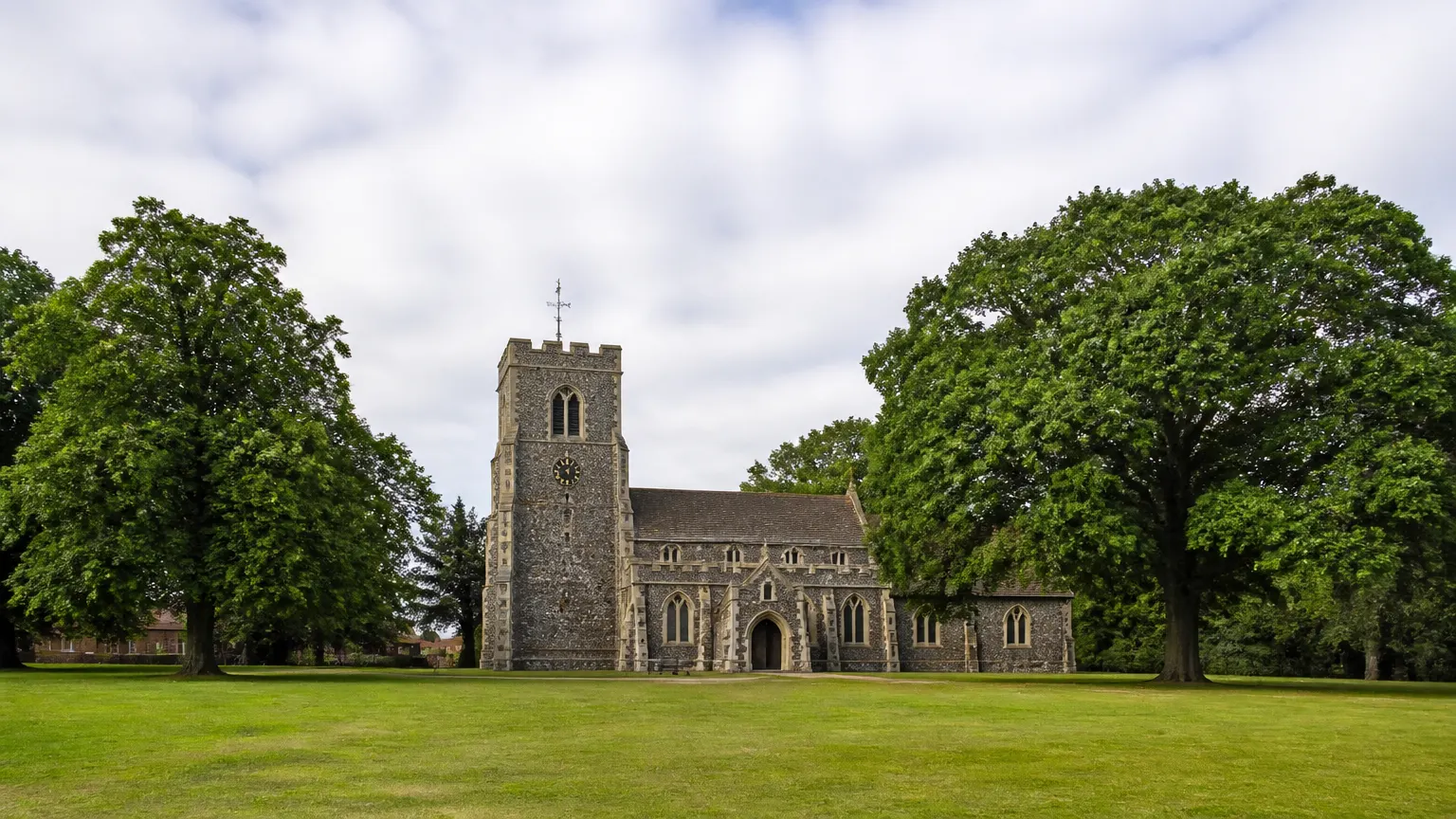 All Saints Church on Chislehurst in South East London with kites flying over the open heath